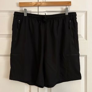 Santiny XL black athletic shorts 7” inseam, 4 zip pockets. New with tags.